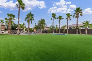 Let the kids run around and chase each other on the fake grass - 5BR Mesa Home 4600 sq.ft | Pool, Hot Tub, Putting Green, In-Ground Trampoline, Half Court Basketball (Mesa)