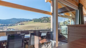 A dining area with a view of a valley and mountains. - Lovely ski in-ski out lodge with sauna (Sankt Lambrecht)