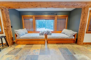 A room with a wooden bench seating area, a window with blinds, and a tiled floor. - The Sunflower-Secluded luxury,hot tub,minutes to town (Skyland & Surrounding Areas)