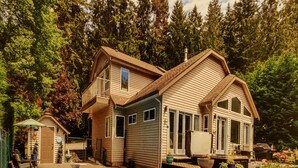 A two-story house with a large deck and a swimming pool. - ocean dock and pool art villa  (Ladysmith)