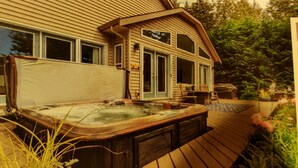 A hot tub in front of a house with a deck and a garden. - ocean dock and pool art villa  (Ladysmith)