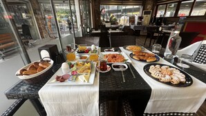 A dining table set with various dishes, glasses, and cutlery. - Dolphin Park Hotel (Ortaca)