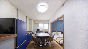 A compact hotel room with a kitchenette, a dining area, and a bed. - Comfy Stay MR2 (Nara)