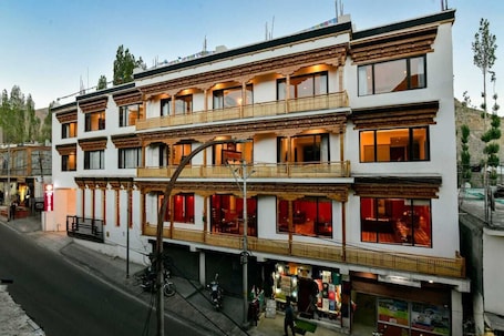 A multi-story building with balconies and large windows, likely a hotel or guesthouse.