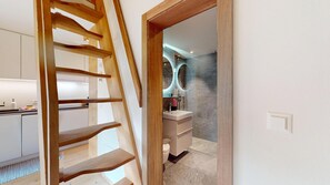 A modern bathroom with a marble floor, a white sink, and a glass shower enclosure. - Beautiful, stylishly furnished 2-room flat on the 2nd floor with gallery, 60 m2, (Sils/Segl Maria)