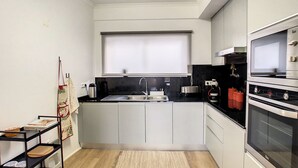 A compact kitchen with a sink, stove, and oven.