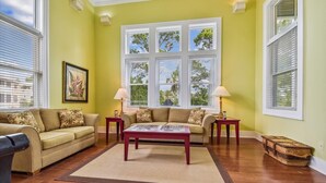 A living room with two sofas, a coffee table, and two lamps. - Welcome to Good Day Sunshine! (St. George Island)