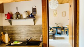 A kitchen with a wooden countertop, a sink, and a hanging rack with kitchen utensils. - Modern apartment with WLAN in the old town (near the market square) (Goslar)