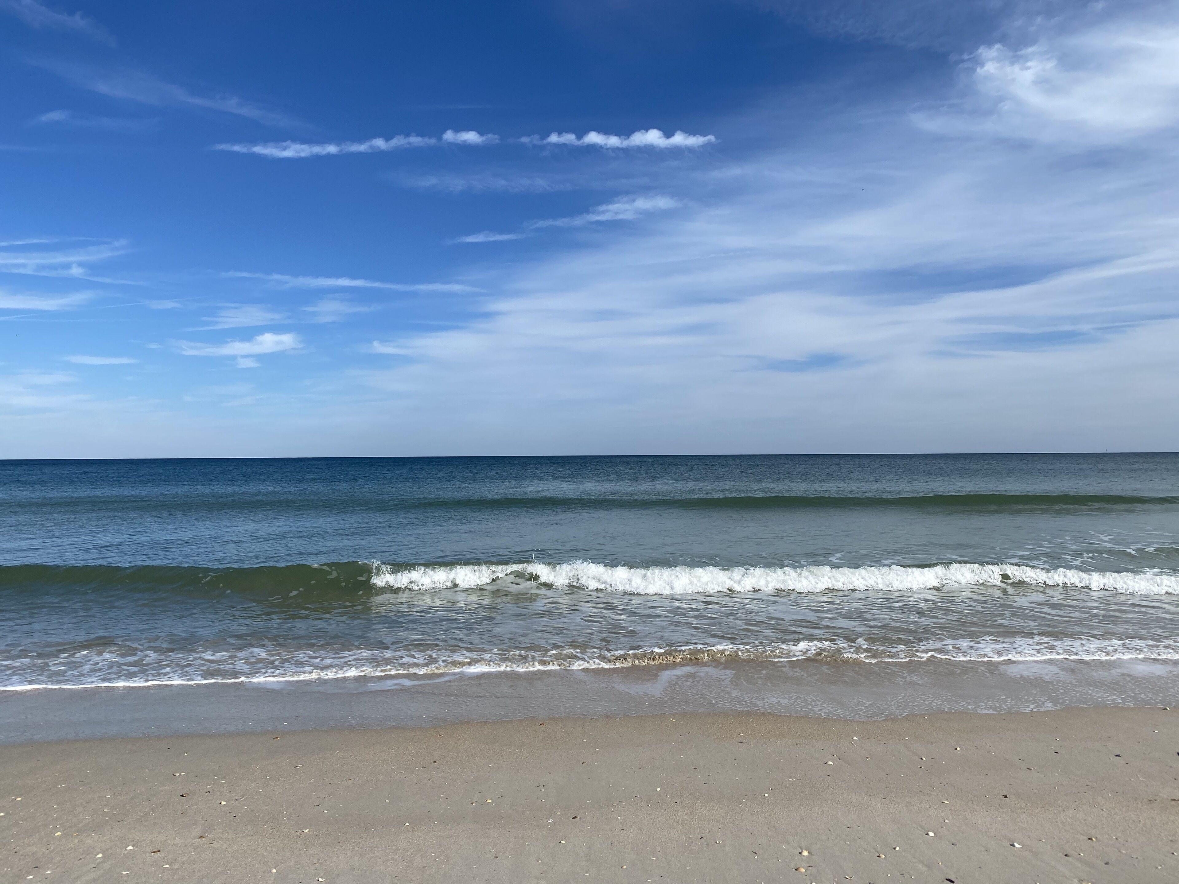 A beach with a clear sky and calm sea.