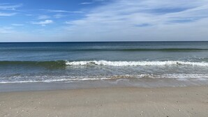 A beach with a clear sky and calm sea.