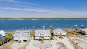 A coastal property with multiple houses, docks, and a large body of water.