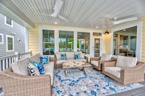 A covered porch with wicker furniture, a patterned rug, and a ceiling fan. - Bayside * 5BR New Luxury House (Selbyville)