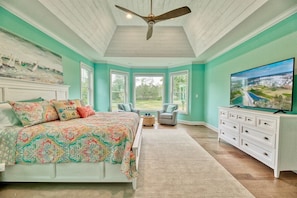 A bedroom with a bed, a television, a ceiling fan, and a view of the outdoors. - Bayside * 5BR New Luxury House (Selbyville)