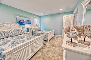 A bedroom with two beds, a nightstand, a lamp, a window, and a fish decoration. - Bayside * 5BR New Luxury House (Selbyville)