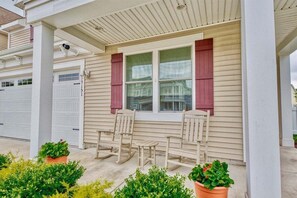 A house with a porch, two rocking chairs, and potted plants. - Coastal Club * 5BR Luxury Beach House (Lewes)