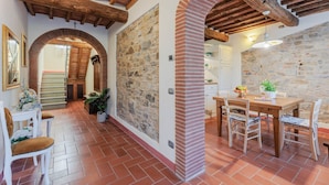 A rustic interior with exposed wooden beams, stone walls, and a tiled floor. - Villa Dondolino, a Stylish Farmhouse with Private Pool close to Lucca and the Beach (Lucca)