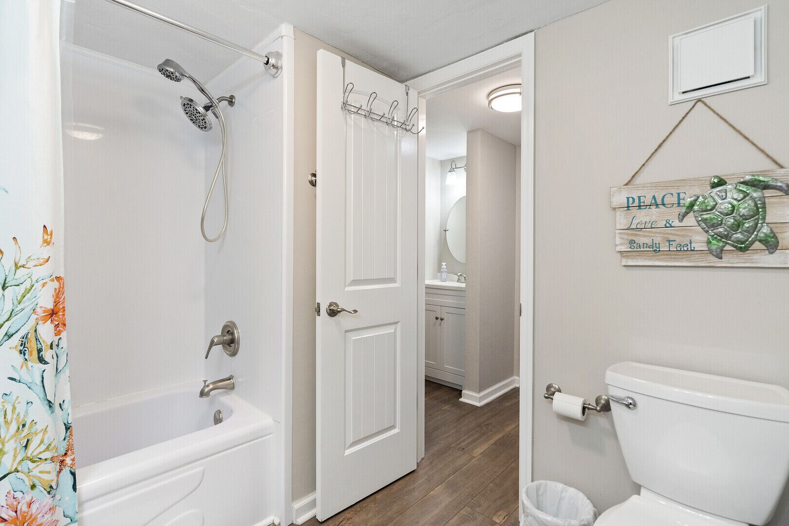 A bathroom with a bathtub, toilet, and shower.