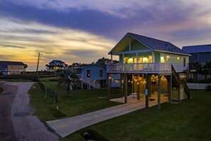 A two-story house with a balcony and a covered porch area.