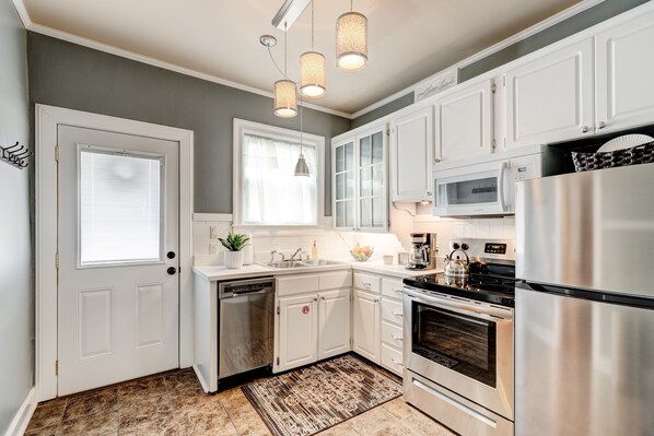 Enjoy cooking in this well-equipped kitchen with a dishwasher, oven, microwave, and refrigerator.