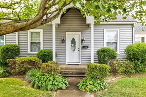 Stunning facade with a central entrance, arched window, and lantern-style lights.