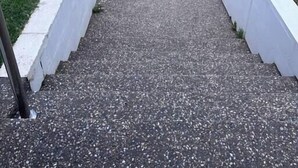 A concrete staircase leading to a gated area with a view of the ocean. - Strangeways Stays! -Slps 10, 4 Bdrm, Oceanview (Port Elliot)