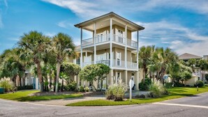 A multi-story building with balconies, surrounded by palm trees and well-maintained lawns. - Latitude Adjustment | Luxury Beach Retreat ☀️ | 15% Off July Weeks (Miramar Beach)