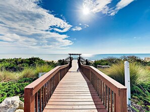 A wooden boardwalk leading to a gazebo by the sea. - Cinnamon Beach Sunrise: Unit 853 (Palm Coast)