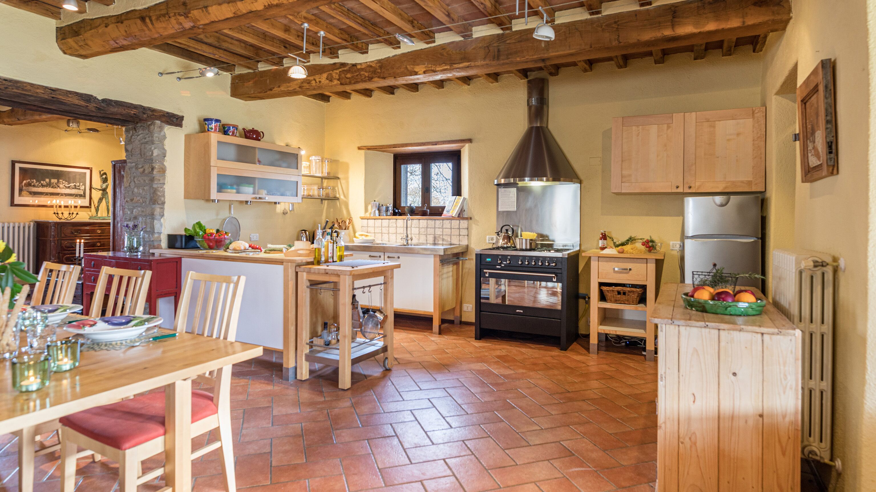 A kitchen with wooden cabinets, a stove, and a refrigerator.
