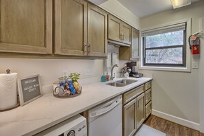 Enjoy a well-equipped kitchen with a dishwasher and a window offering a view of the outdoors.