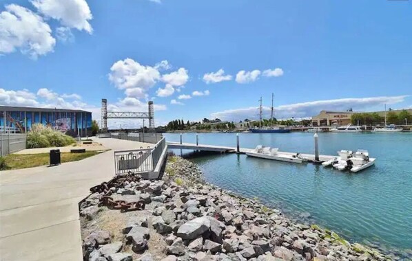 Enjoy waterfront views from the hotel's dock, where boats are moored and a paved walkway leads to the shore.