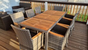 A wooden deck with a table and chairs.