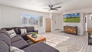 A modern living room with a sofa, coffee table, and TV.