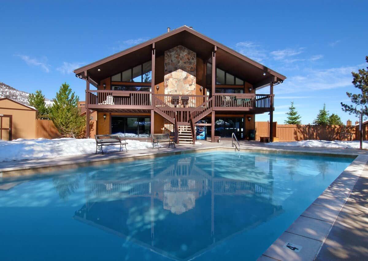 A two-story building with a pool in front.