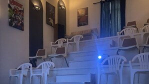 A lecture hall with tiered seating, white plastic chairs, and posters on the walls. - 35 min to Louisville, 45 to Churchill Downs. Indoor Basketball court. (Fredericksburg)
