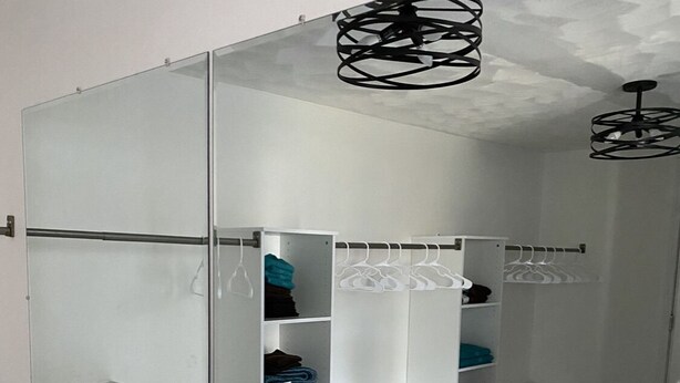 A modern bathroom with a large mirror, marble flooring, and a walk-in shower. - 35 min to Louisville, 45 to Churchill Downs. Indoor Basketball court. (Fredericksburg)