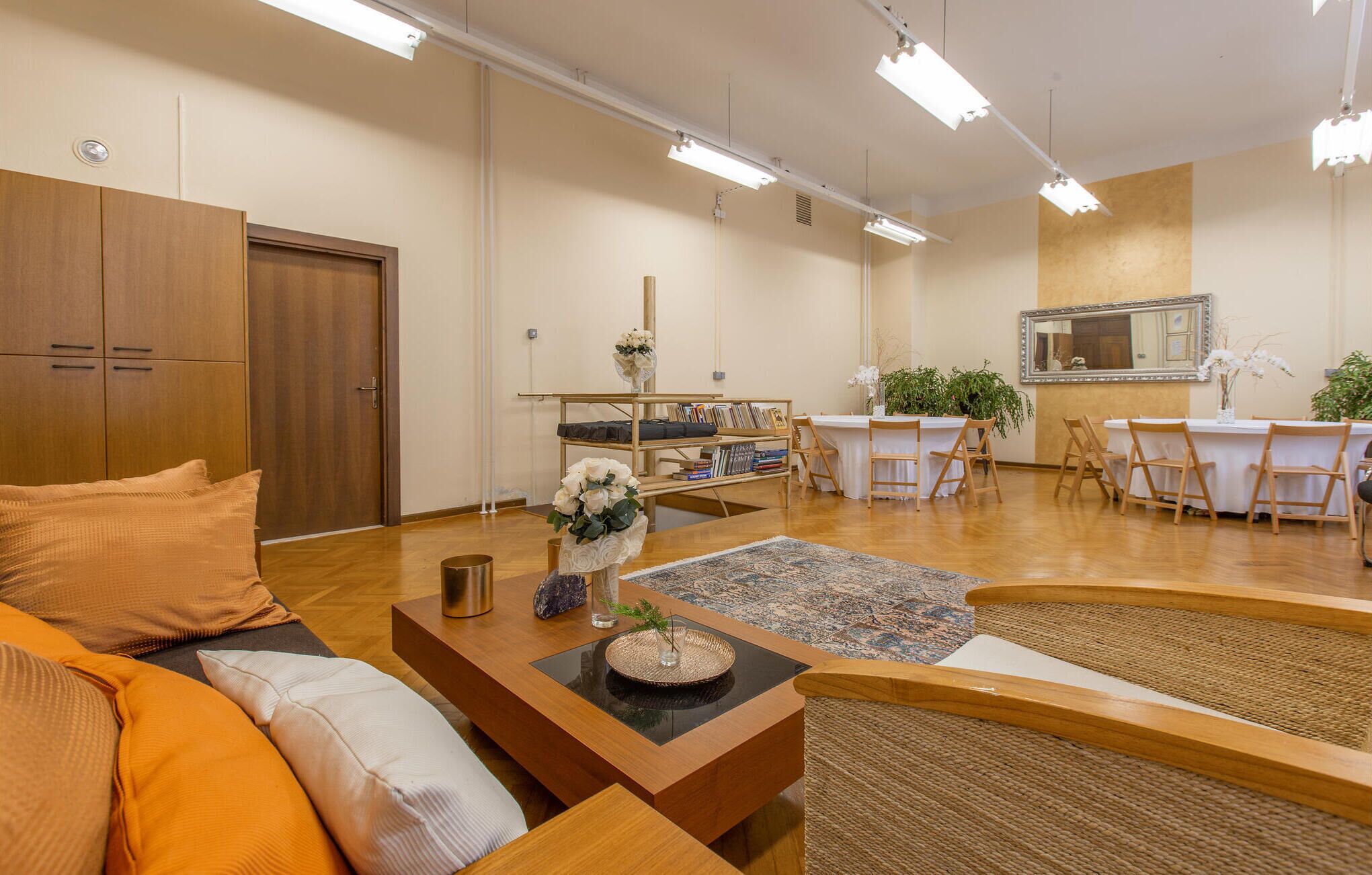 A modern living room with a sofa, coffee table, and dining area.