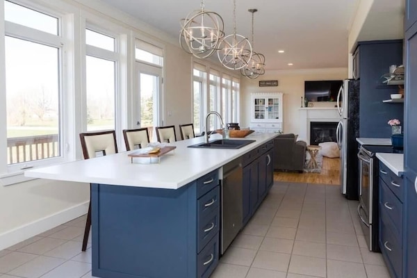 Open concept kitchen with seating for four at the island.
