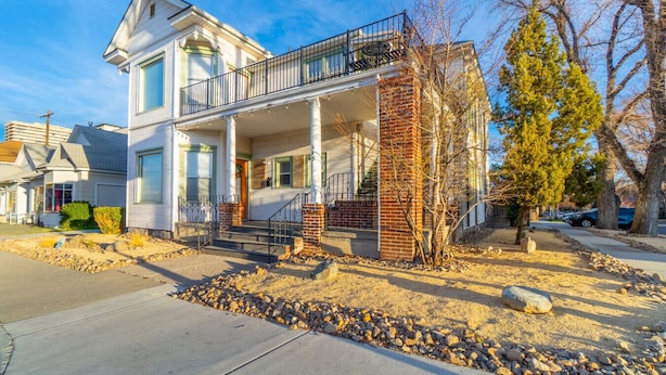 A two-story house with a balcony, a front porch, and a brick column. - Rustic Studio walking distance to Downtown (Reno)