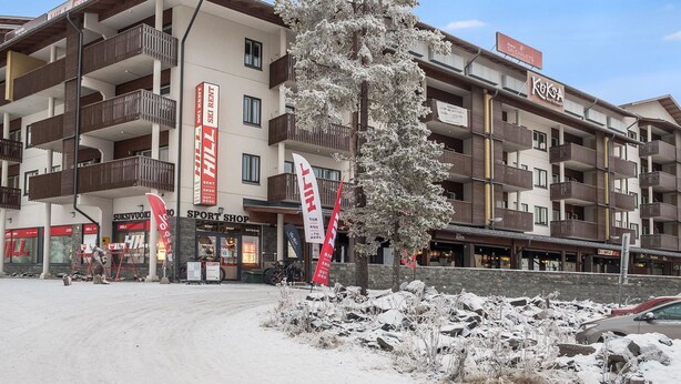 A multi-story hotel with balconies, a ski rental shop, and a restaurant. - Ruka ski chalets 64, 1302 by Interhome (Kuusamo)