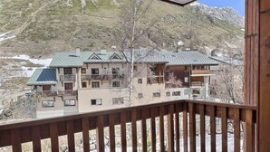 A view from a balcony overlooking a mountain with buildings.