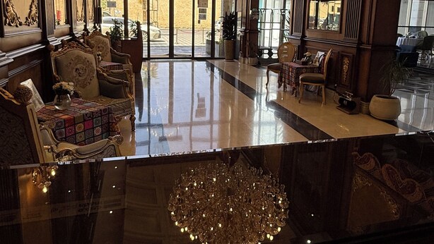 A grand lobby with ornate chandeliers, plush seating, and large windows offering views of the street. - AL Rahden Hotel  (Riyadh)