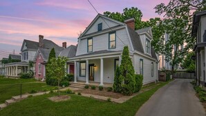 A two-story house with a front porch, a chimney, and a well-maintained lawn. - This house is a 3 bedroom(s), 2.5 bathrooms, located in Lexington, KY. (Lexington)