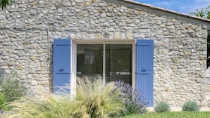 A stone building with blue shutters and a glass door. - Gîte Les Oliviers Côté Lavande, near Vaison La Romaine  (Crestet)