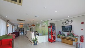 A hotel lobby with a reception desk, seating area, and a refrigerator. - Hotel O Northern Inn (Kota Marudu)