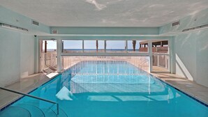 An indoor swimming pool with clear views of the beach and ocean. - Gulf-Front, Sweeping Views, 2 Pools, Sleeps 6 + Free Attraction Tickets! (Panama City Beach)