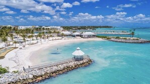 A beach resort with a white sandy beach, clear turquoise waters, and a small pavilion. - G-34B Cap Cana Punta Palmera Beach Studio Ocean View NEW! (Punta Cana)