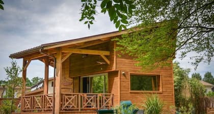 Le colibri, wooden house near river and forest