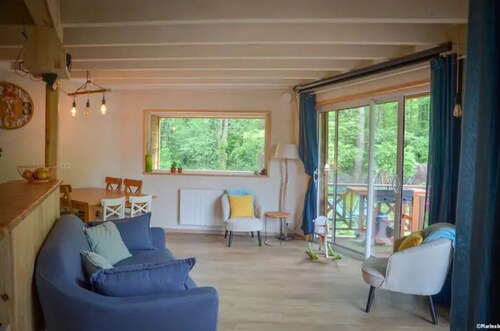 Le colibri, wooden house near river and forest