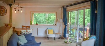 Le colibri, wooden house near river and forest