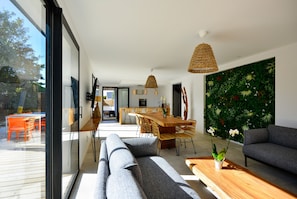 Enjoy meals together in this spacious dining area with a comfortable sofa and stylish seating.
